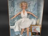 the barbie doll is in a box with a picture of marilyn monroe on it