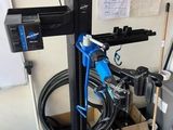 a machine that is sitting in a garage with a hose