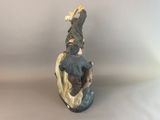 figurine of a man riding a horse with a bird on top of it