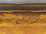 a close up of a piece of wood with a design on it