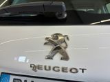 a white car with a logo on the front of it