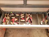 a lot of different types of valves in a drawer