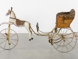 a horse pulling a carriage with a horse on it