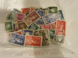 many different stamps in a plastic container on the table