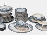 a lot of plates and cups and saucers on the table