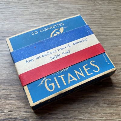 des cigarettes sont posées sur une table en bois, à côté d'un paquet de cigarettes