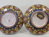 pair of blue and yellow plates with a lion on them