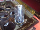 a glass sitting on top of a box on a table