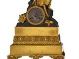 two clocks that are sitting side by side on a white surface