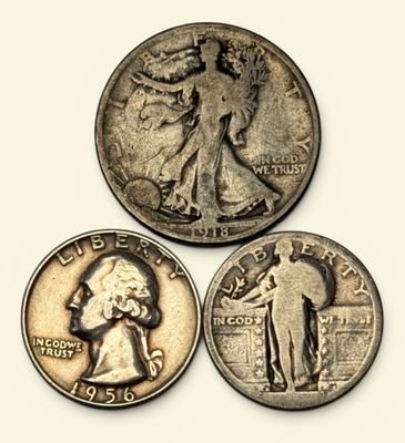 a close up of three different coins on a white surface