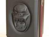 an image of a black suitcase with a gorilla face on it