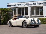 a white car parked in front of a building