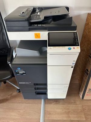 a black and white printer sitting on top of a black chair