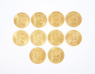 gold coins arranged in the shape of a heart on a white surface