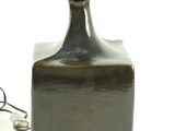 a small black bottle with a light on top of it