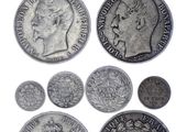 a close up of a bunch of coins on a white surface