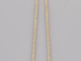 a gold necklace with a black stone on a chain