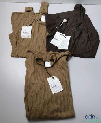 trois t-shirts pour homme, encore étiquetés, posés sur une table
