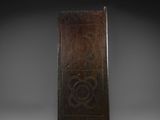 an old wooden door with a carved design on the front
