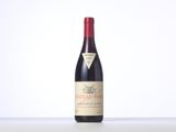 a bottle of red wine sitting on top of a table