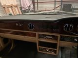 a dashboard of a car in a garage with a lot of wood