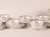 a lot of cups and saucers sitting on a table