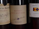 several bottles of wine are lined up on a shelf