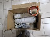 a cardboard box with a bunch of white cups in it