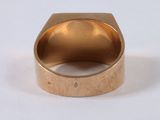 an image of a close up of a gold ring on a white surface