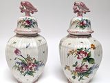 pair of vases with birds and flowers painted on them on a white background