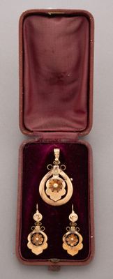a small box with a necklace and earrings inside of it