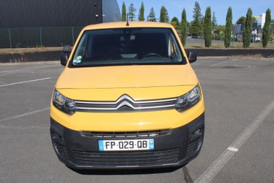 a yellow van that is parked in a parking lot