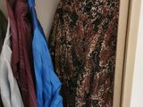 a closet with clothes hanging on a clothes rack