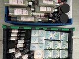 many bottles of different colors and sizes of paint in a container