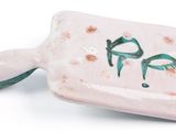 pink and green ceramic spatula with green handles on a white surface