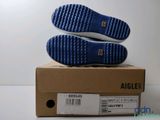 the soles of a pair of blue shoes are on top of a box