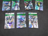 six packs of pokemon trading cards sitting on a black surface