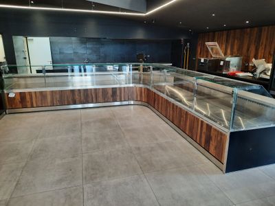 a glass display case in the middle of a kitchen