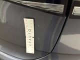 a sticker on the front of a car that has a price tag attached to it
