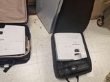 two open suitcases sitting on the floor next to each other