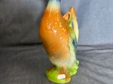 a figurine of a duck that is sitting on a table