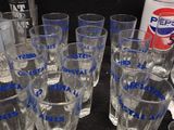 many glasses and a can of pepsi on the table