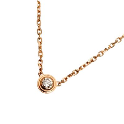 a close up of a necklace with a diamond on a chain