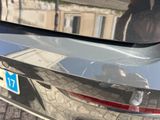 a reflection of a person in the rear window of a car