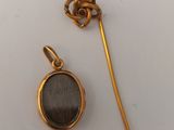 a close up of a gold plated object with a black stone