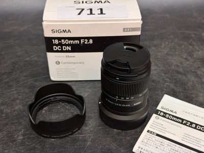 a camera lens sitting on top of a table next to a box