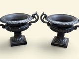 two black vases sitting on top of each other