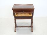 a small wooden table with a drawer on top of it