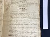 an old book with writing on it sitting on top of a table