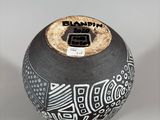 a black and white vase with a design on it